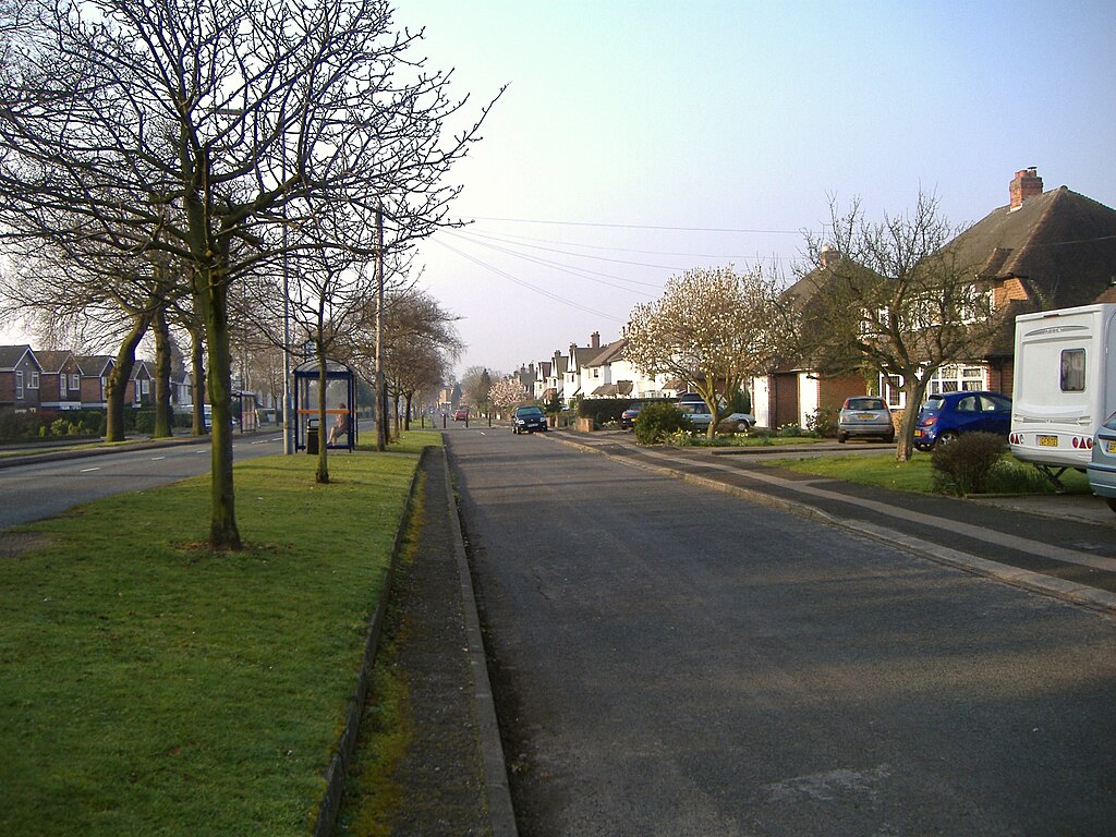 A scenic view of Walmley village, Sutton Coldfield, with residential homes and greenery.